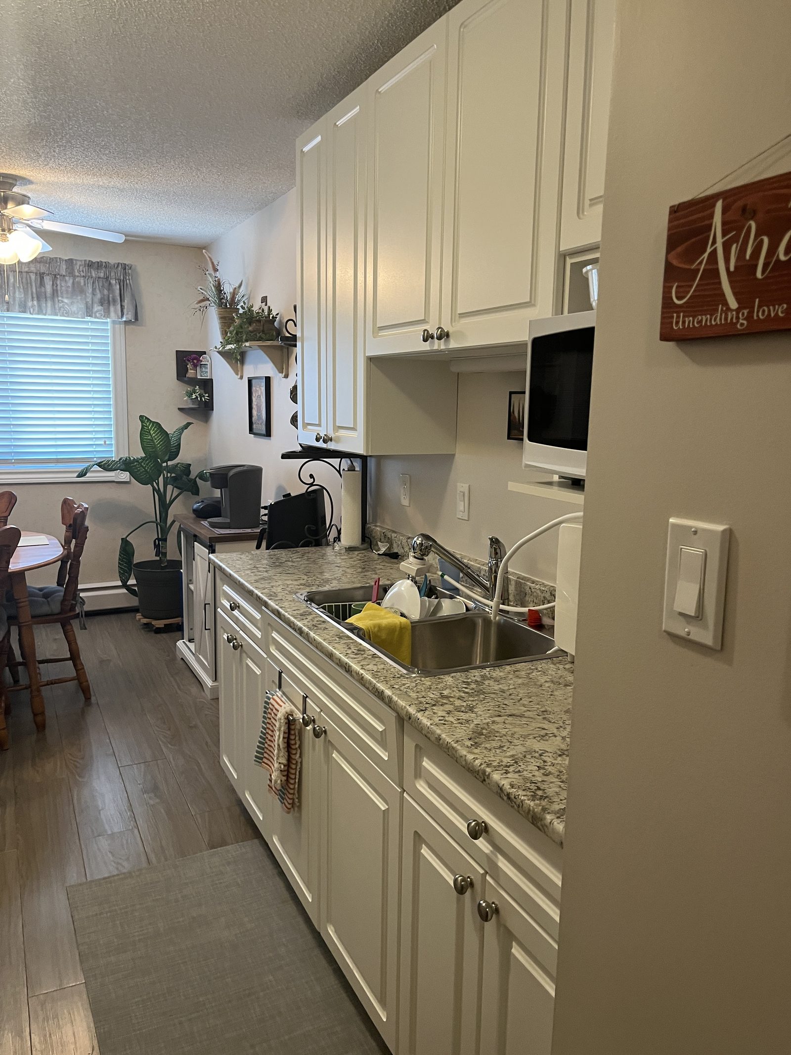 Suite kitchen at Valleyview with white cabinets and stone-look counters